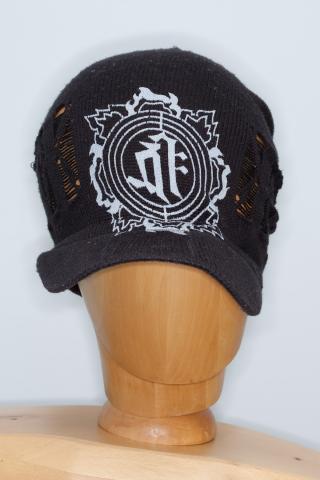 a distinctive knitted dark cap with a large white logo outlined with three circles